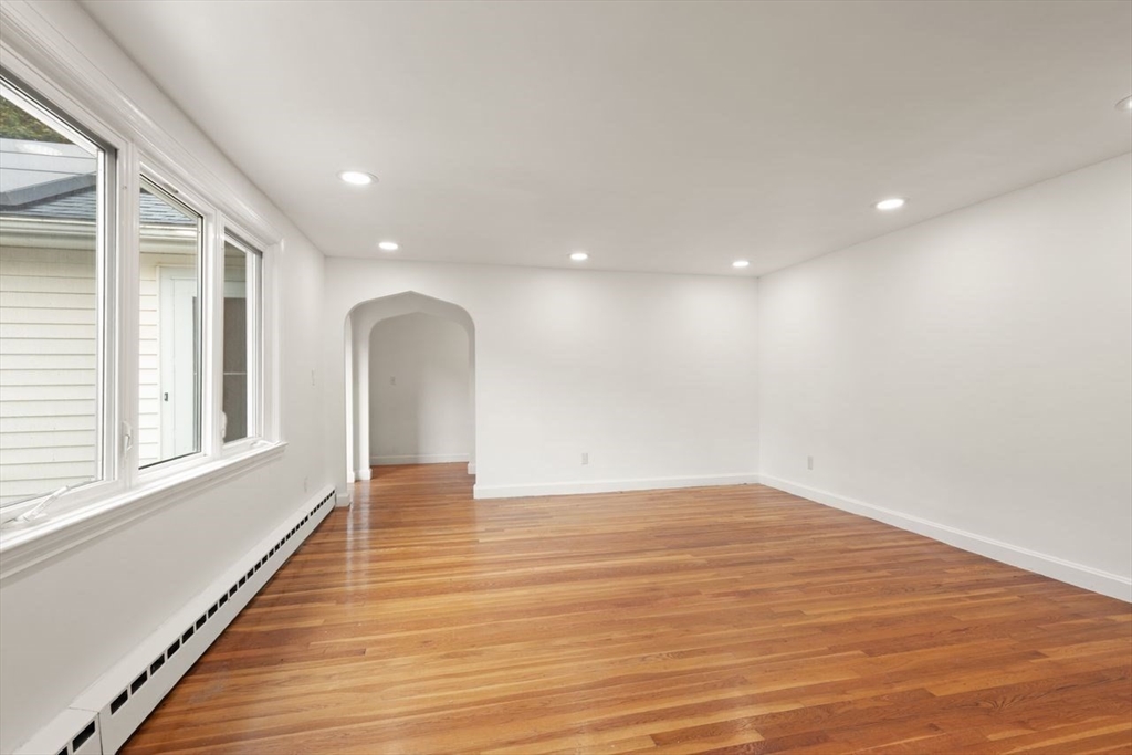 8 Margaret Road Sharon, MA 02067 - Photo 6 of 32 a view of an empty room with wooden floor and a window