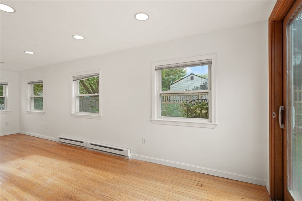 8 Margaret Road Sharon, MA 02067 - Photo 7 of 32 an empty room with wooden floor and windows
