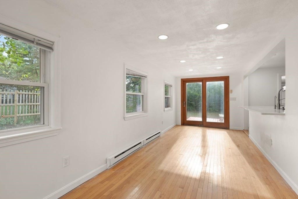 8 Margaret Road Sharon, MA 02067 - Photo 9 of 32 an empty room with wooden floor and windows