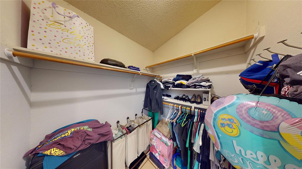 1317 Colonial Place Flower Mound, TX 75028 - Photo 11 of 20 Walk-in closet featuring extensive shelving and clothing rods