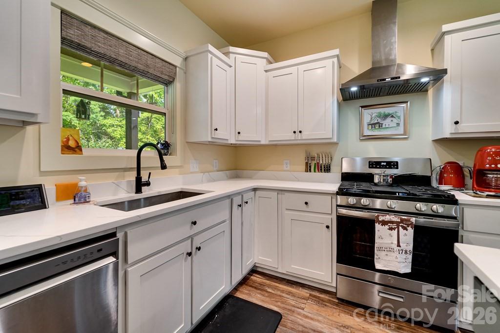 190 Fort Hembree Road Hayesville, NC 28904 - Photo 12 of 18 a kitchen with a stove a sink and a window