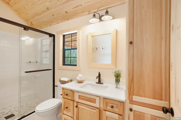 a view of a balcony with wooden floor and furniture