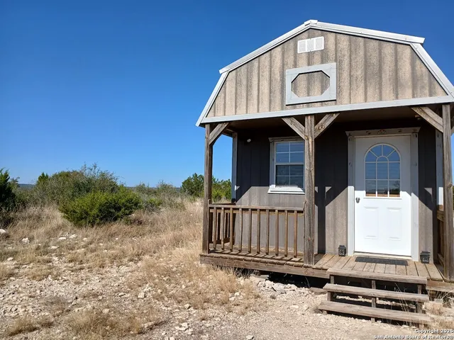 a view of front door of house with stairs