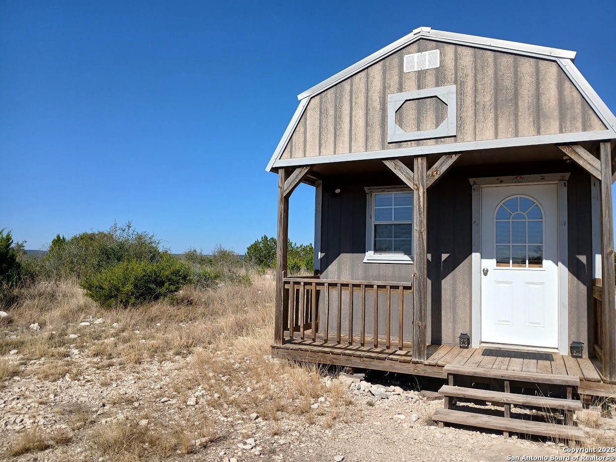 300 County Road 550 Rocksprings, TX 78880 - Photo 26 of 32 a view of a house with a yard