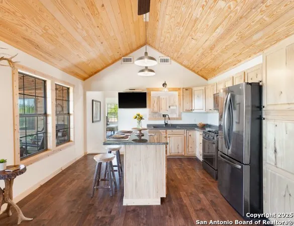 a living room with furniture gym equipment and large windows