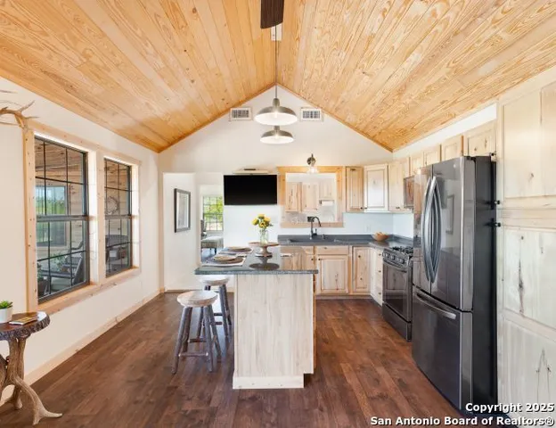 a living room with furniture gym equipment and large windows