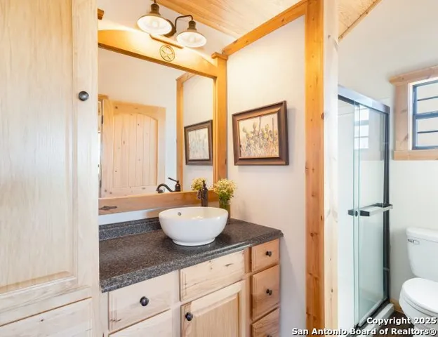 a kitchen with stainless steel appliances a sink a stove and white cabinets