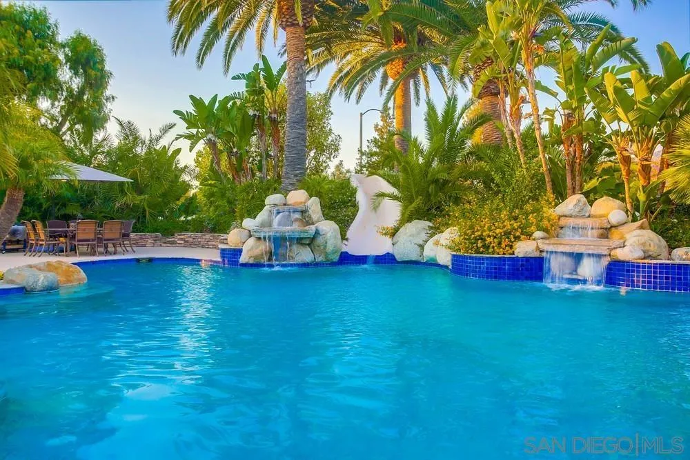 16255 Summer Sage Road Poway, CA 92064 - Photo 54 of 74 a front view of a house with swimming pool garden and trees