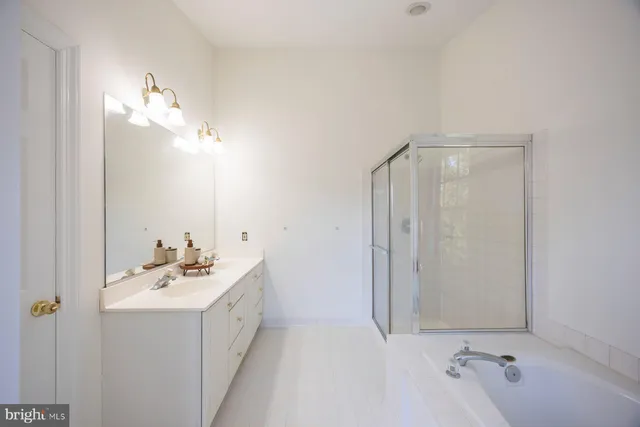 a bathroom with a double vanity sink and a mirror