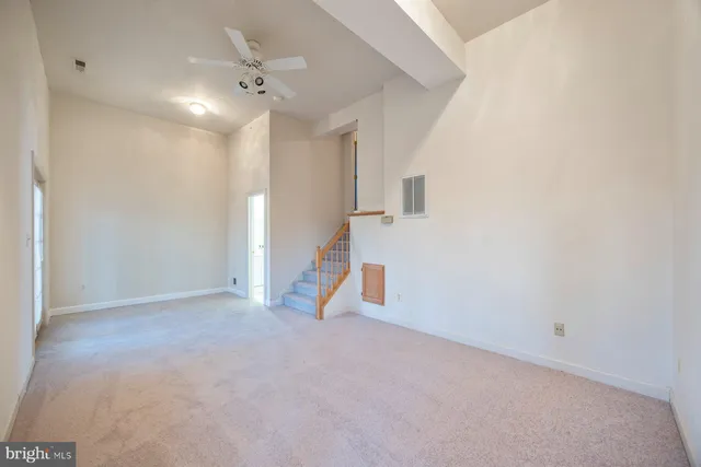 a view of an empty room with a ceiling fan