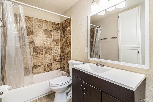 a view of kitchen with stainless steel appliances granite countertop a stove and a refrigerator