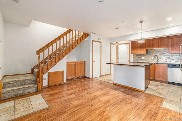 a view of kitchen with kitchen island dining table and wooden floor