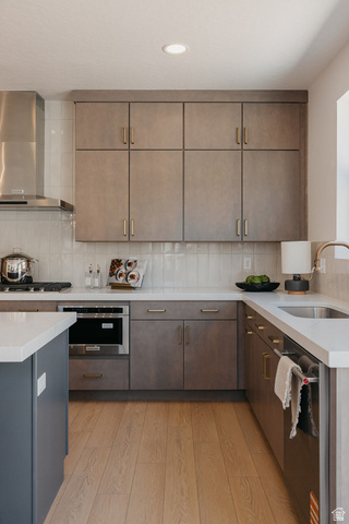 5902 Canyon Rim Road, Unit 620 Lehi, UT 84048 - Photo 13 of 78 Modern kitchen featuring light wood-finish flooring, white countertops, and a white subway tile backsplash