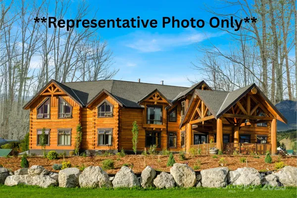 a view of a lush green hillside and houses