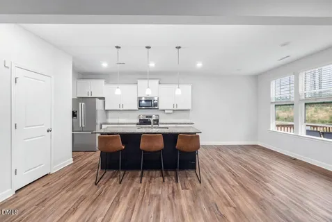 a view of wooden floor and windows in a room
