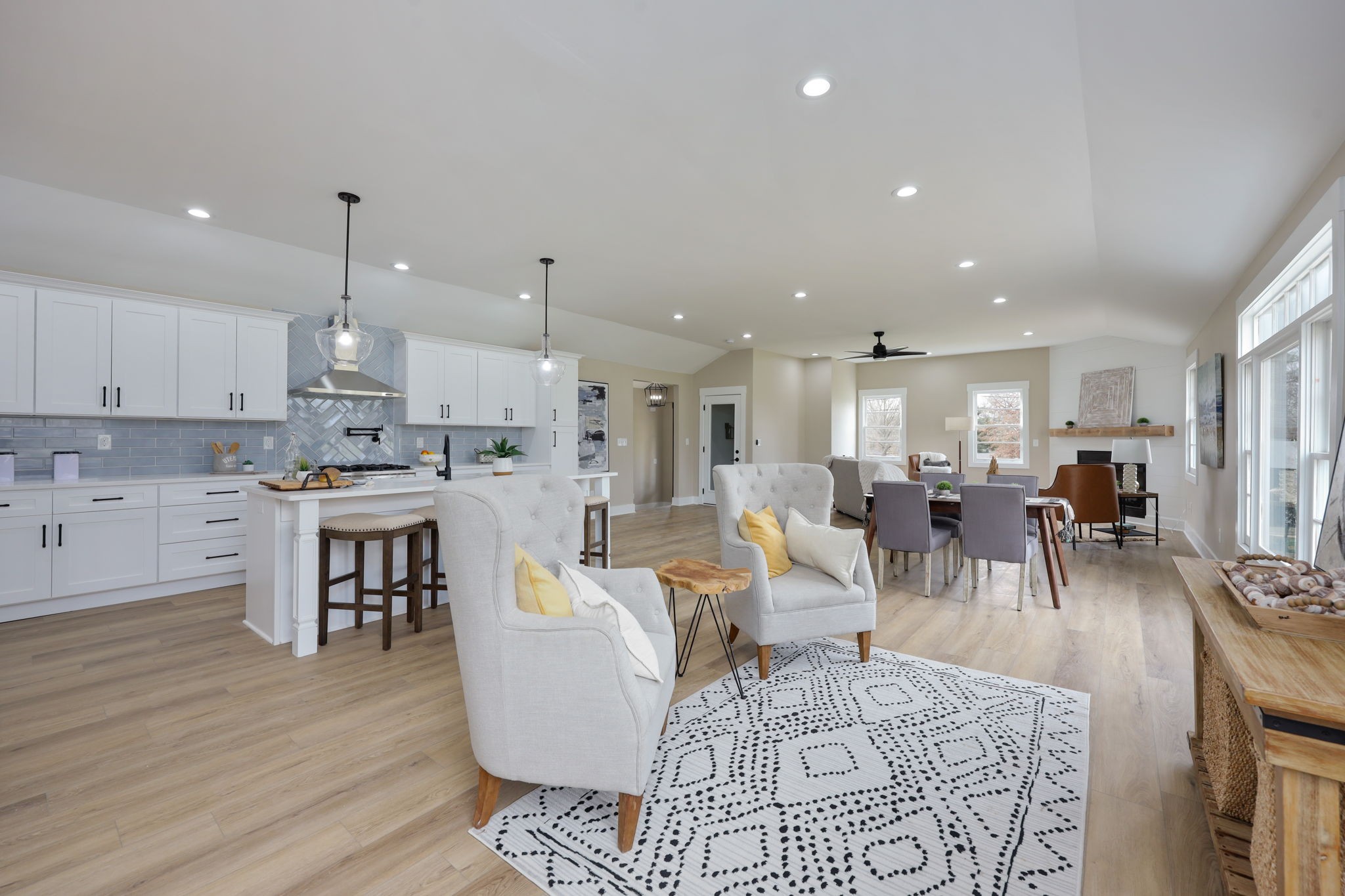 a living room with lots of furniture and kitchen view