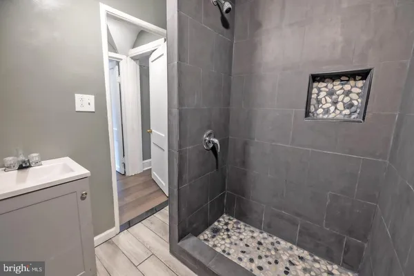 a bathroom with a sink a toilet a shower and a mirror