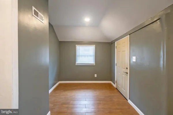 a view of room with window and hardwood floor