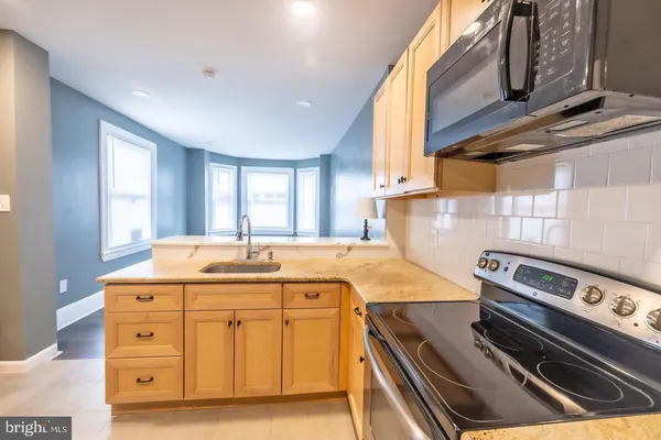 a kitchen that has a stove and a sink