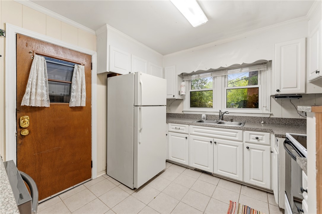 2807 Bellview Road Anderson, SC 29621 - Photo 7 of 31 White cabinetry paired with durable countertops and tile flooring defines this functional kitchen workspace.