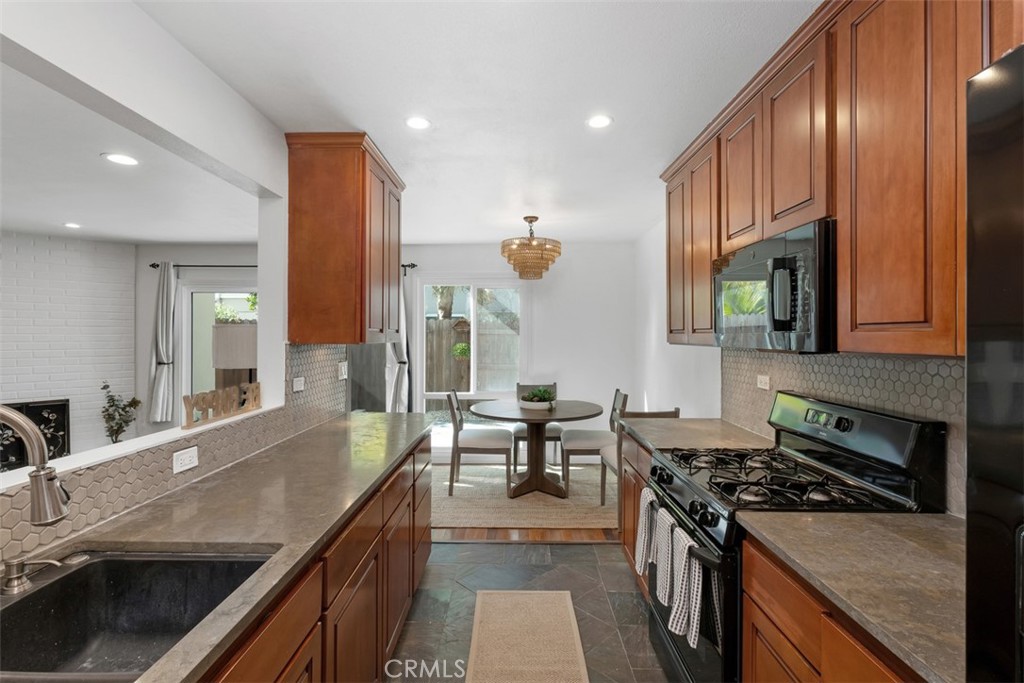 1741 Tustin Avenue, Unit 17C Costa Mesa, CA 92627 - Photo 11 of 36 a kitchen with sink stove and cabinets