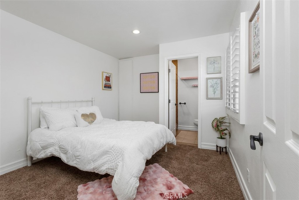 1741 Tustin Avenue, Unit 17C Costa Mesa, CA 92627 - Photo 12 of 36 a bedroom with a bed and wooden floor