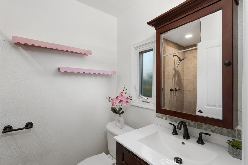 1741 Tustin Avenue, Unit 17C Costa Mesa, CA 92627 - Photo 13 of 36 a bathroom with a sink mirror and vanity