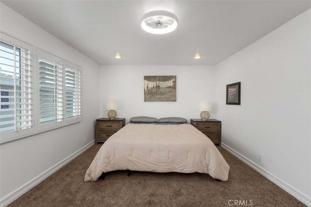 1741 Tustin Avenue, Unit 17C Costa Mesa, CA 92627 - Photo 15 of 36 a bedroom with a bed and a window