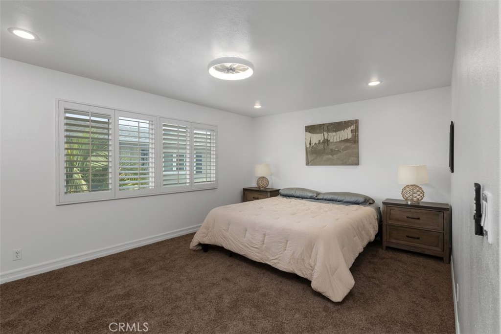 1741 Tustin Avenue, Unit 17C Costa Mesa, CA 92627 - Photo 16 of 36 a bedroom with a bed and a table