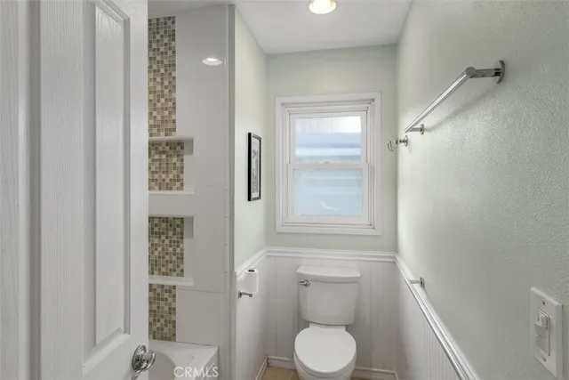 a bathroom with a toilet and a shower