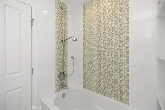 a bathroom with a bathtub and shower
