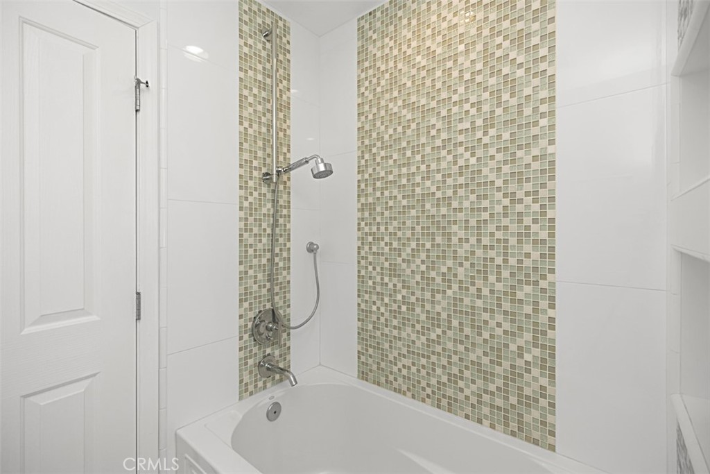 1741 Tustin Avenue, Unit 17C Costa Mesa, CA 92627 - Photo 21 of 36 a bathroom with a bathtub and shower