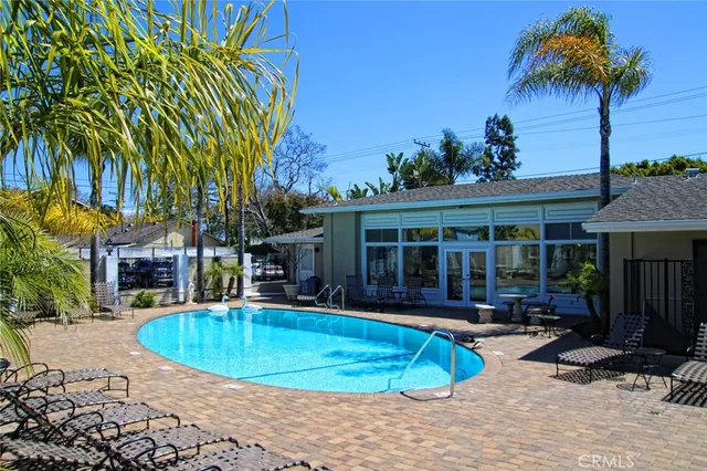 a view of a house with swimming pool and sitting area