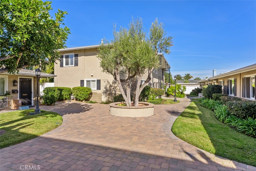 1741 Tustin Avenue, Unit 17C Costa Mesa, CA 92627 - Photo 36 of 36 a view of a garden with a house