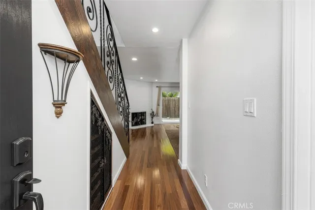 a view of hallway with wooden floor