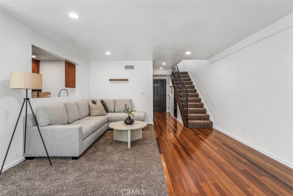 1741 Tustin Avenue, Unit 17C Costa Mesa, CA 92627 - Photo 6 of 36 a living room with furniture and a wooden floor