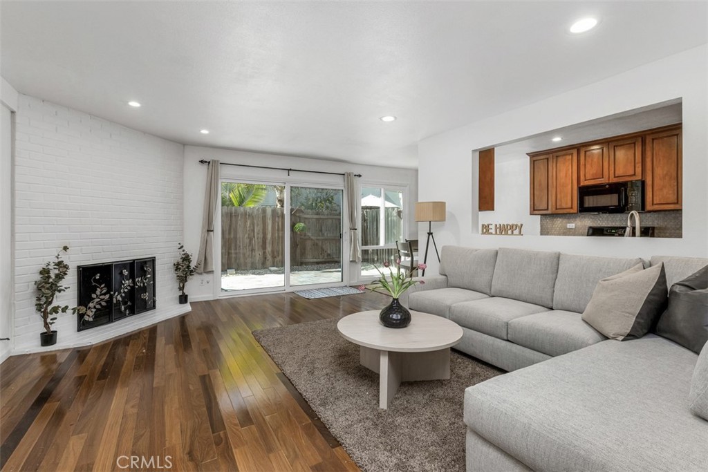 1741 Tustin Avenue, Unit 17C Costa Mesa, CA 92627 - Photo 7 of 36 a living room with furniture and a fireplace