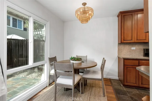 a view of a dining room with furniture and a window