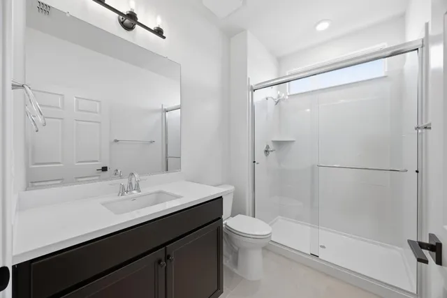a bathroom with a sink shower and a mirror