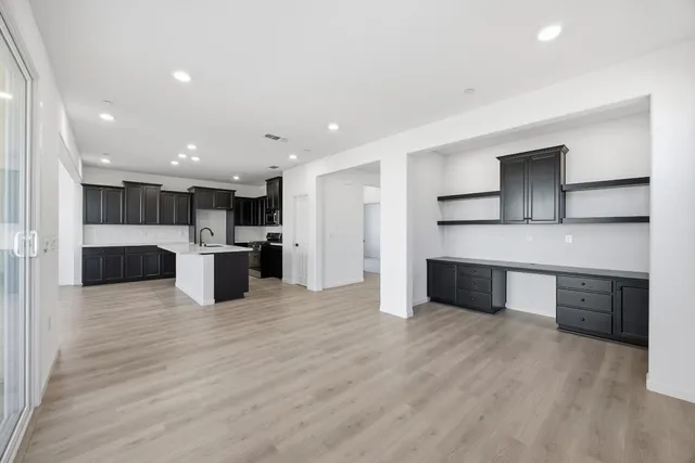 a large kitchen with stainless steel appliances kitchen island a large counter top and a sink