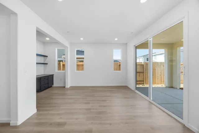 an empty room with windows and entrance