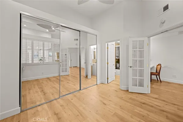 a view of a room with wooden floor and glass door