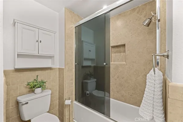 a bathroom with a toilet and a shower