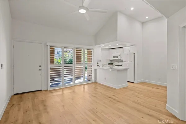 a kitchen with white cabinets and white appliances