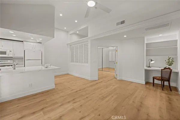 a large room with kitchen view and living room view