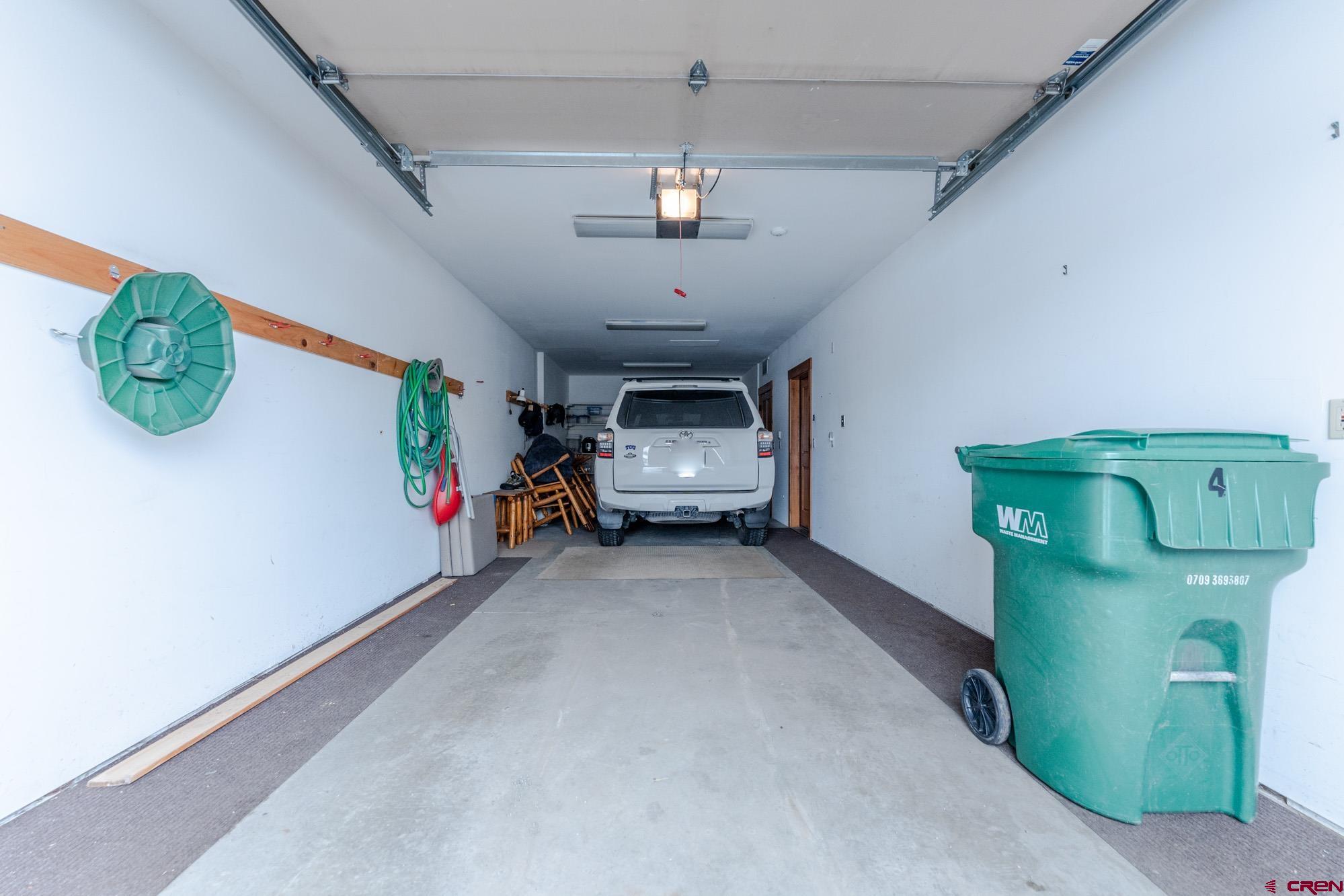 16 Snowmass Road, Unit 4 Crested Butte, CO 81225 - Photo 14 of 35 a bedroom with bed and a chandelier