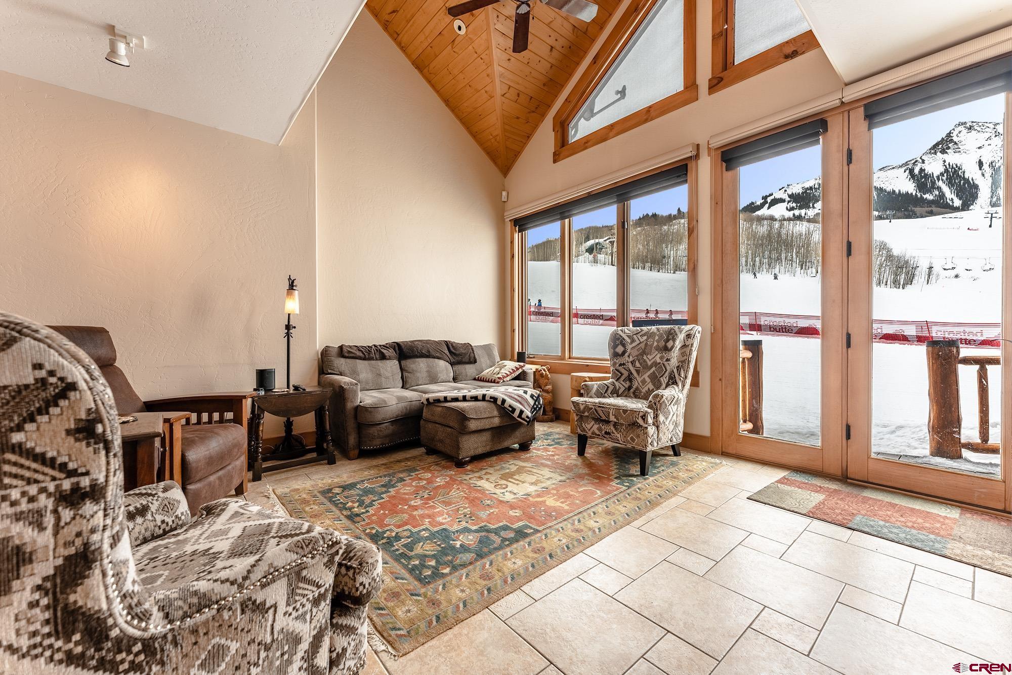 16 Snowmass Road, Unit 4 Crested Butte, CO 81225 - Photo 2 of 35 a living room with furniture and a large window