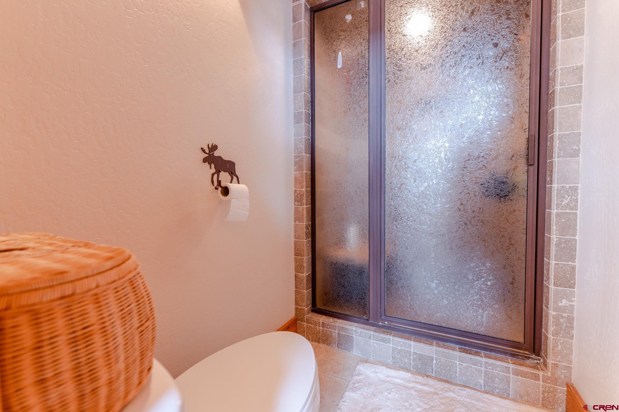 16 Snowmass Road, Unit 4 Crested Butte, CO 81225 - Photo 24 of 35 a bathroom with a granite countertop shower and a toilet