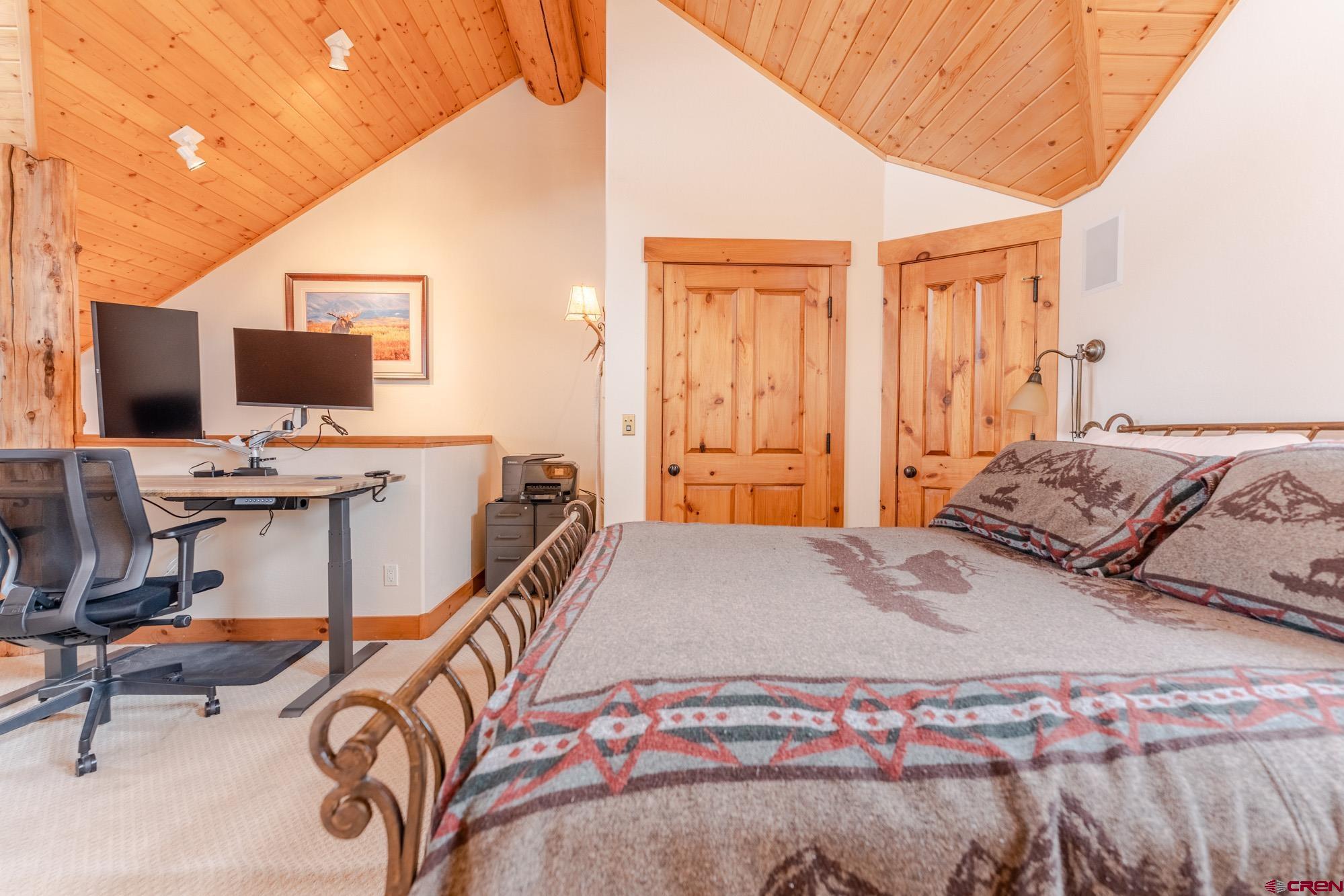 16 Snowmass Road, Unit 4 Crested Butte, CO 81225 - Photo 26 of 35 a bedroom with a bed computer on desk and a chair
