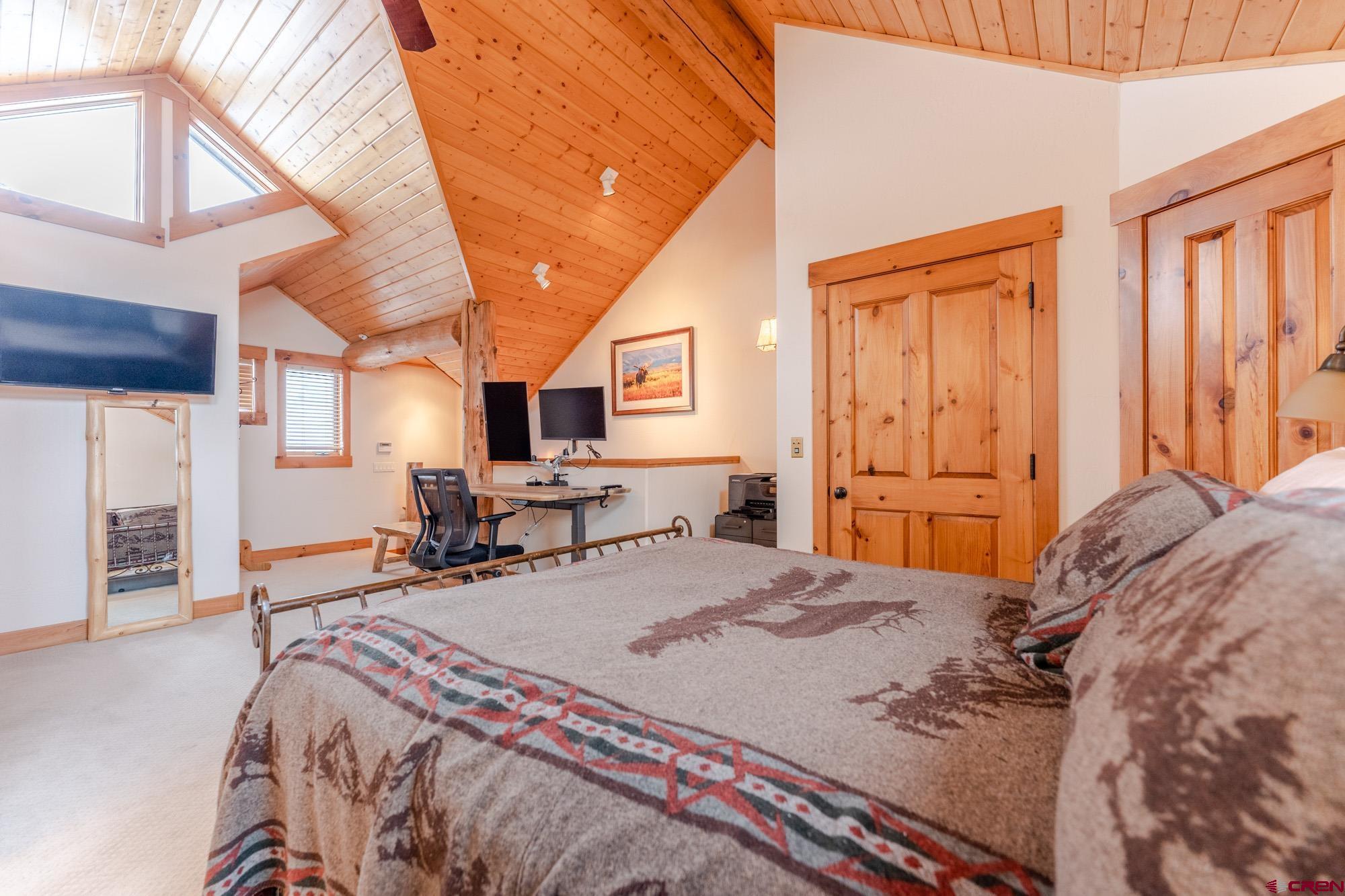 16 Snowmass Road, Unit 4 Crested Butte, CO 81225 - Photo 27 of 35 a bedroom with a bed next to a window